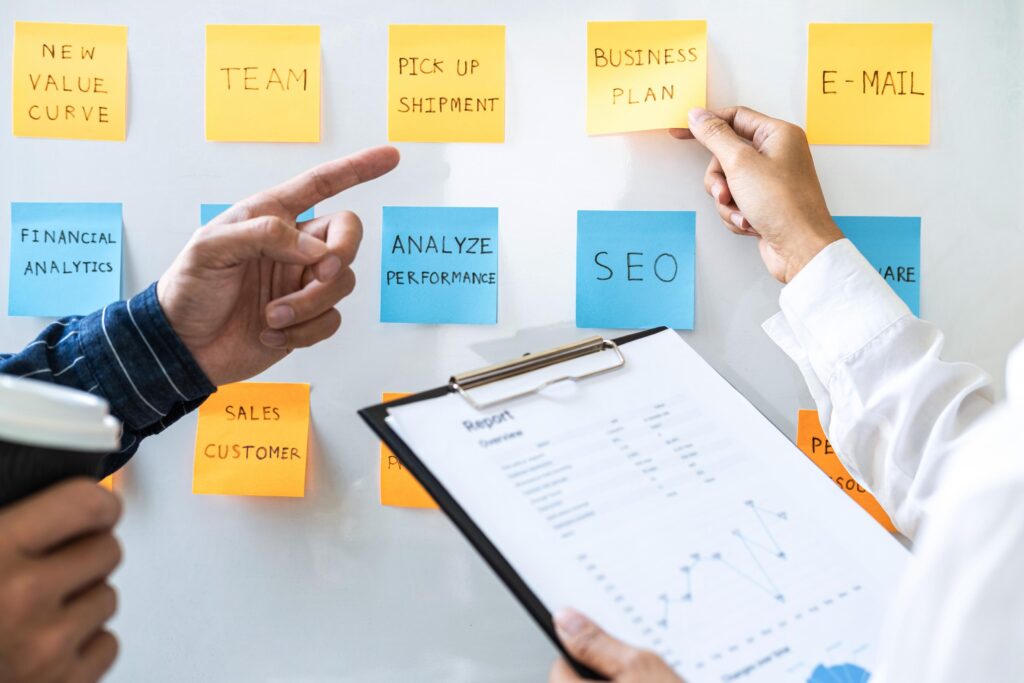 Business Planning Meeting with Sticky Notes and Report